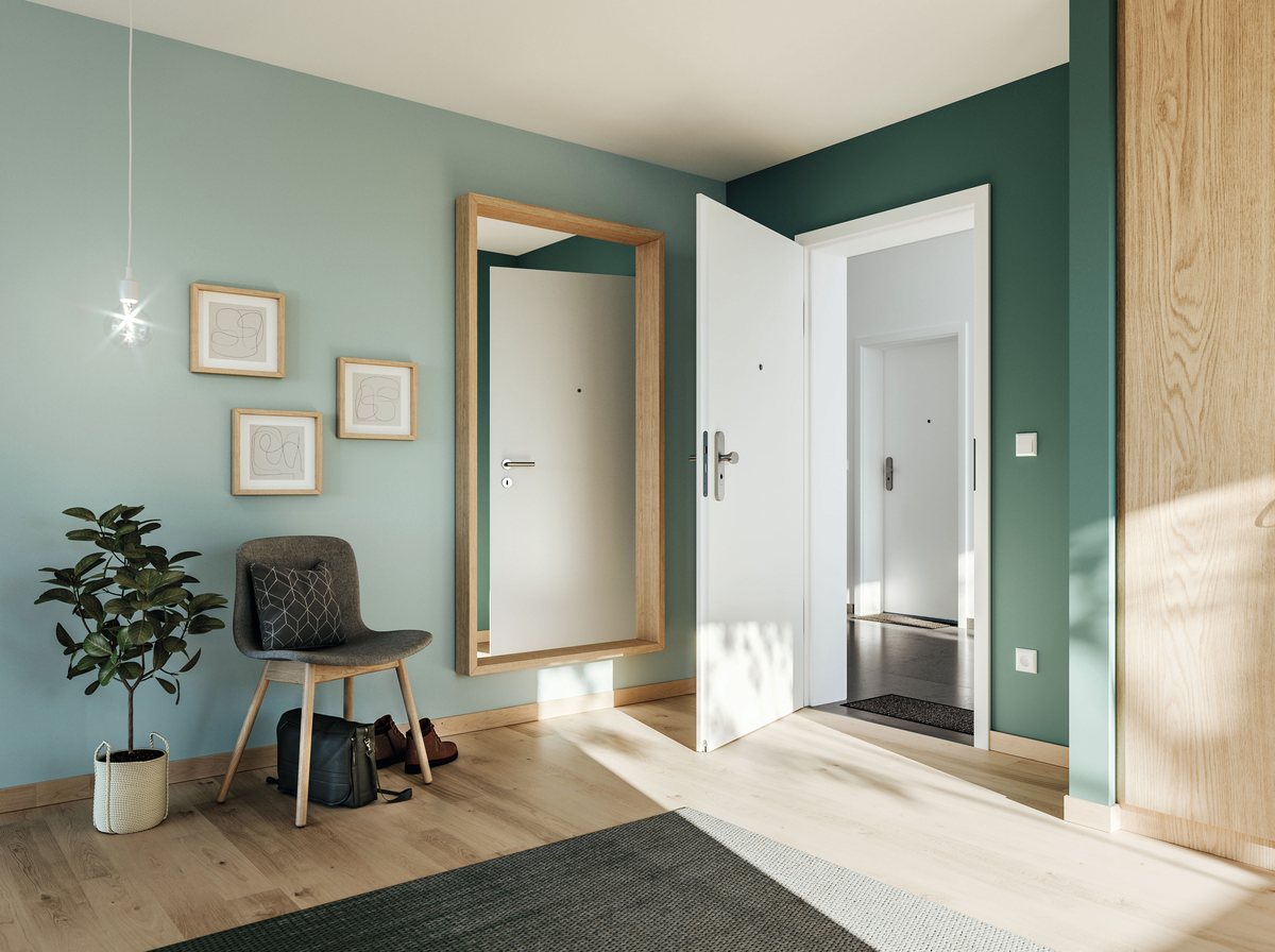Weiße Wohnungseingangstür in einem Flur mit grüner Wand